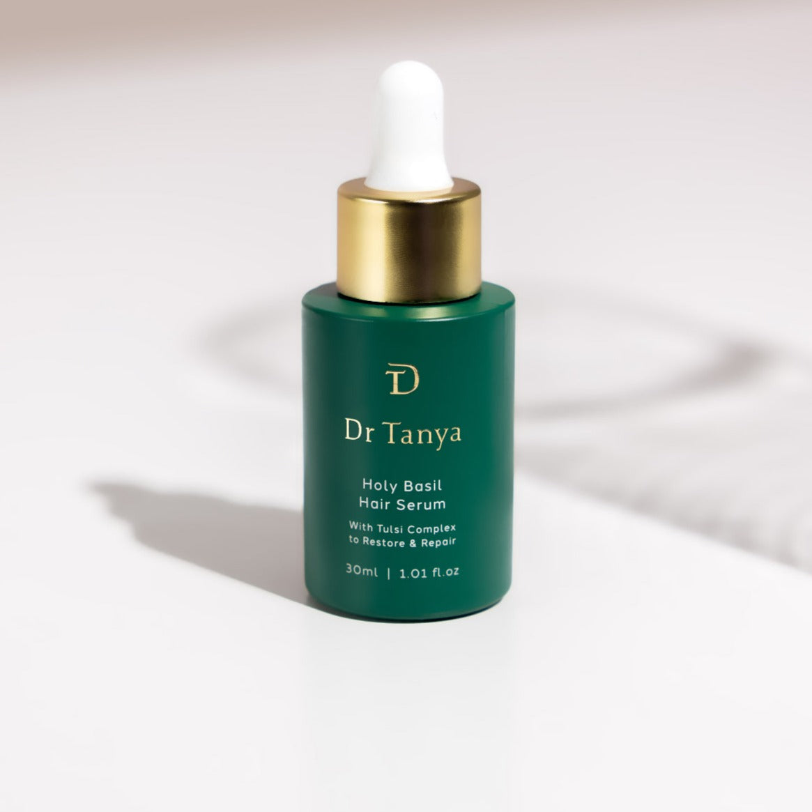 A bottle of Holy Basil hair serum with tulsi complex