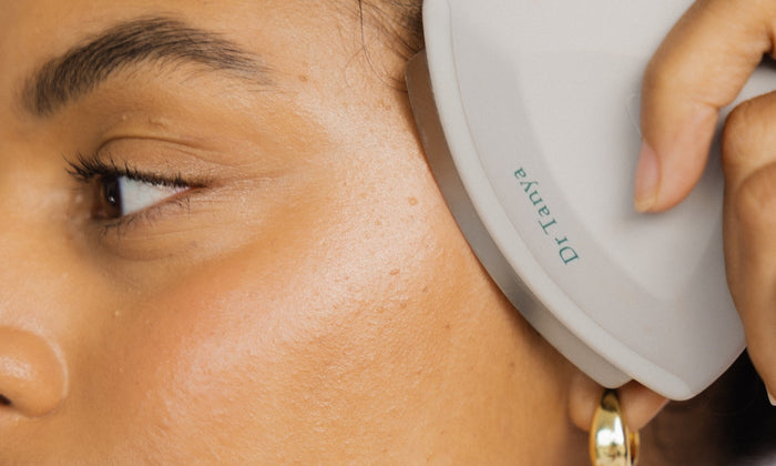 Lady exfoliating her face with Dr Tanya NuSonic face exfoliator device