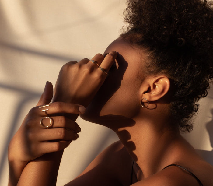 Close up image taken side on of a lady’s hands covering her face 