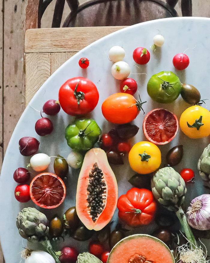 A selection of fruit and vegetables laying on a table