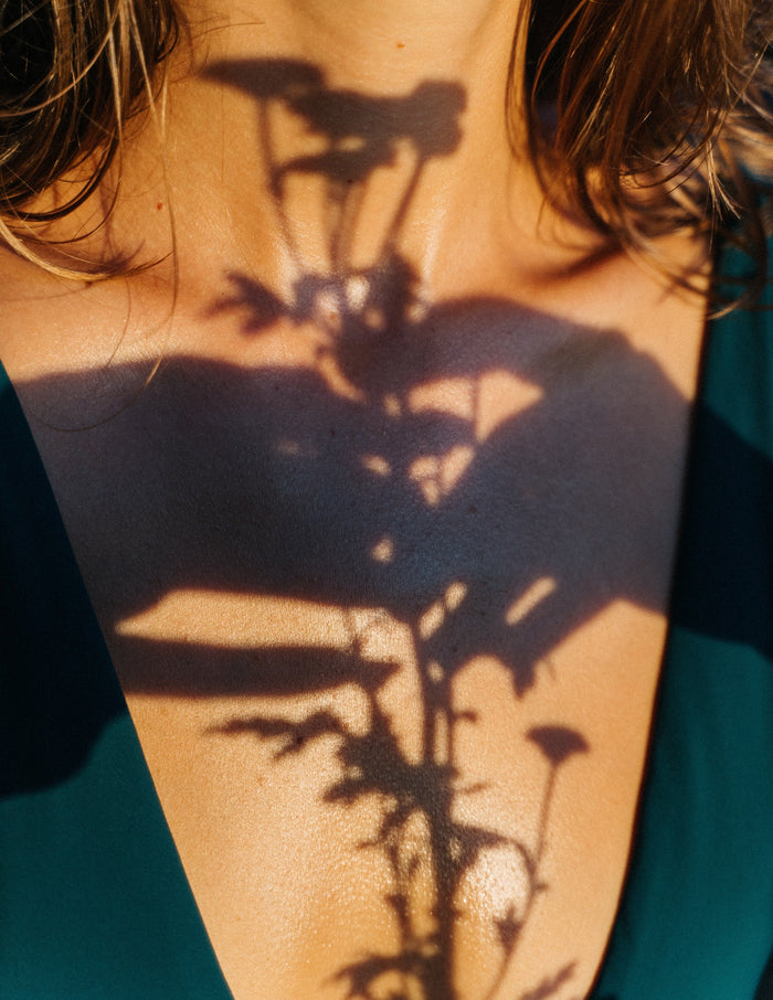 Shadows playing on a woman’s decolletage