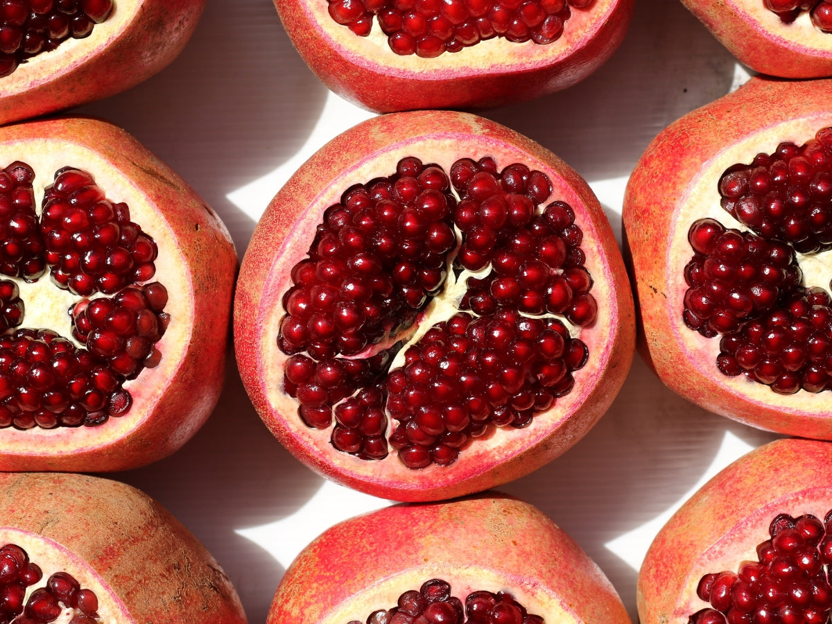 A close-up photo of pomegranates cut in half