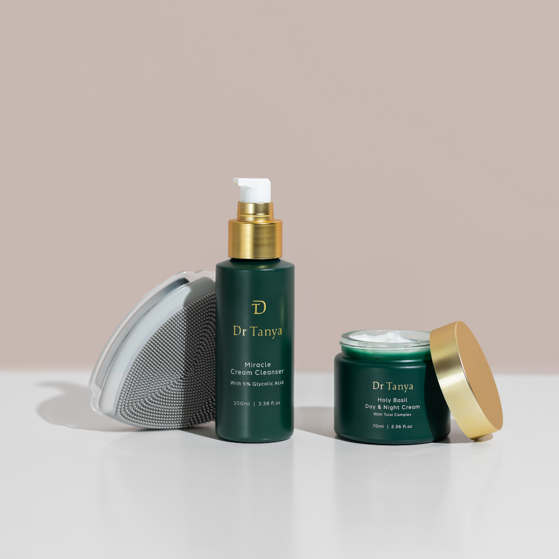 Two green bottles of facial skincare products with the lids off