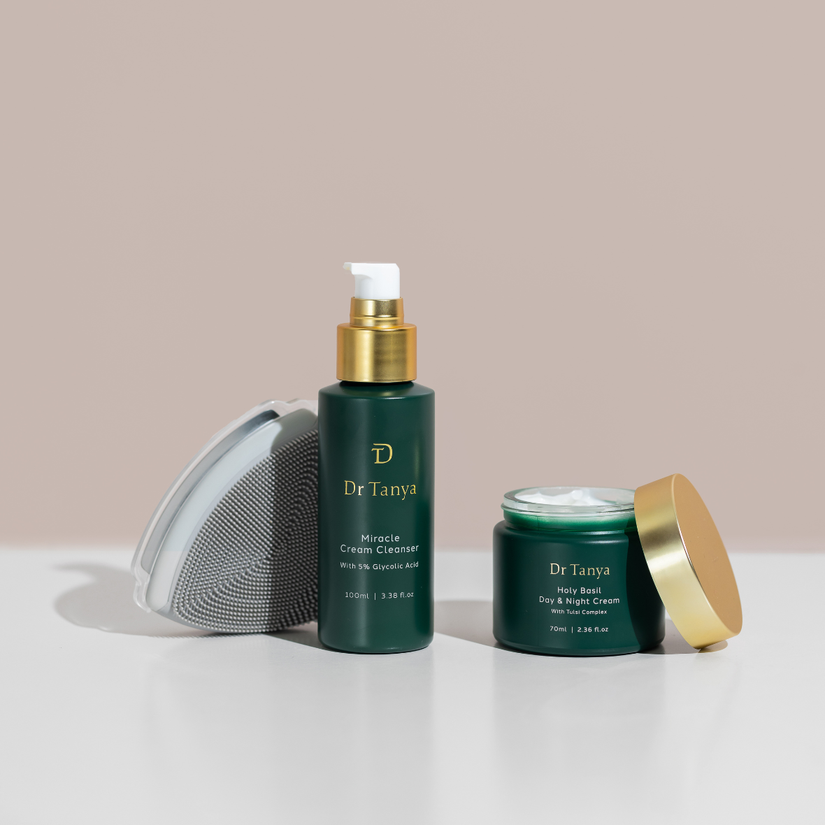 Two green bottles of facial skincare products with the lids off